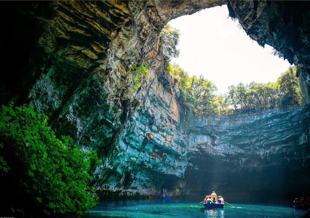 A group of people in a boat in a cave

Description automatically generated