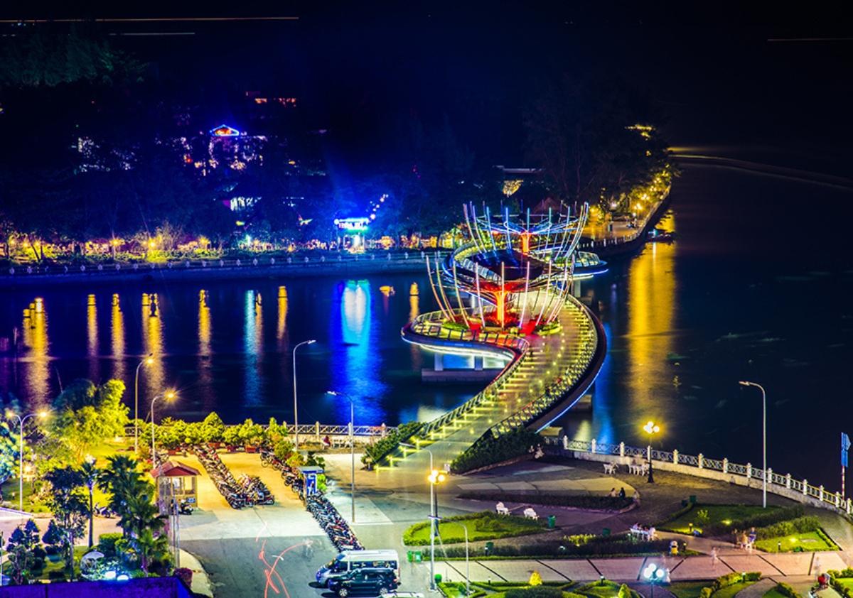 A bridge over water at nightDescription automatically generated